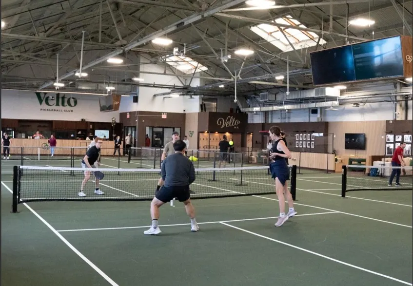Members playing doubles on the indoor courts at Velto