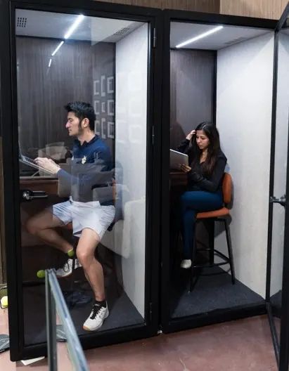 Soundproofed private phone booths beside the courts