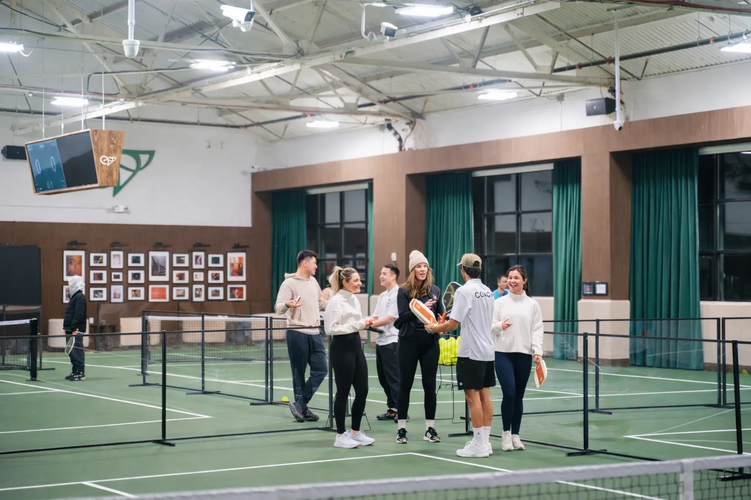 Group of players socializing on the courts at Velto Pickleball Club